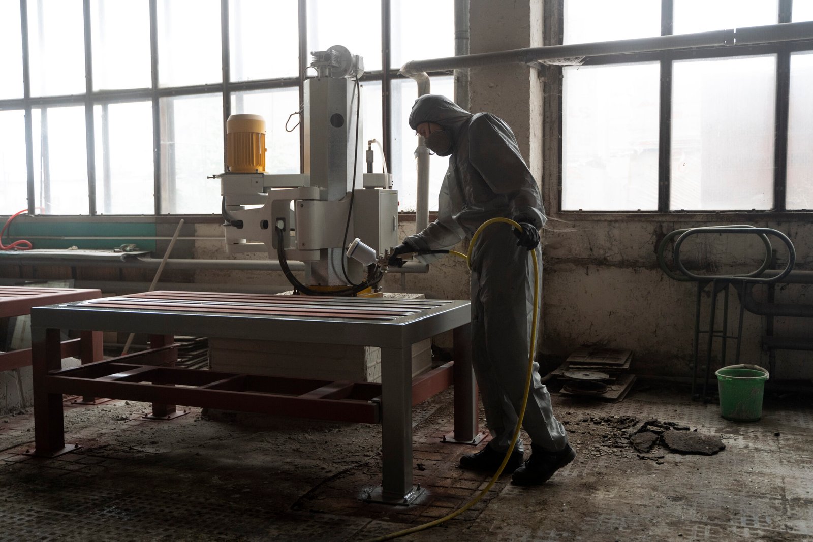 full shot man spraying powder paint from gun scaled
